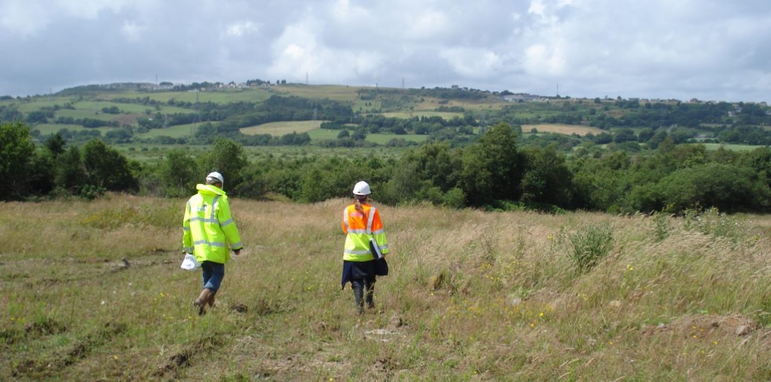 Ecological surveyors walking across grassland